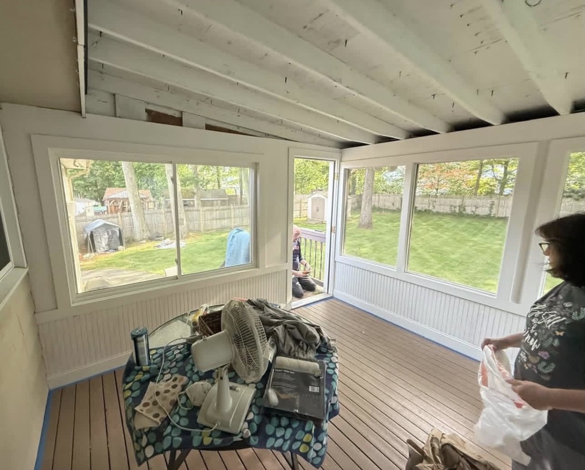 Porch wall paneling and window trim during the project